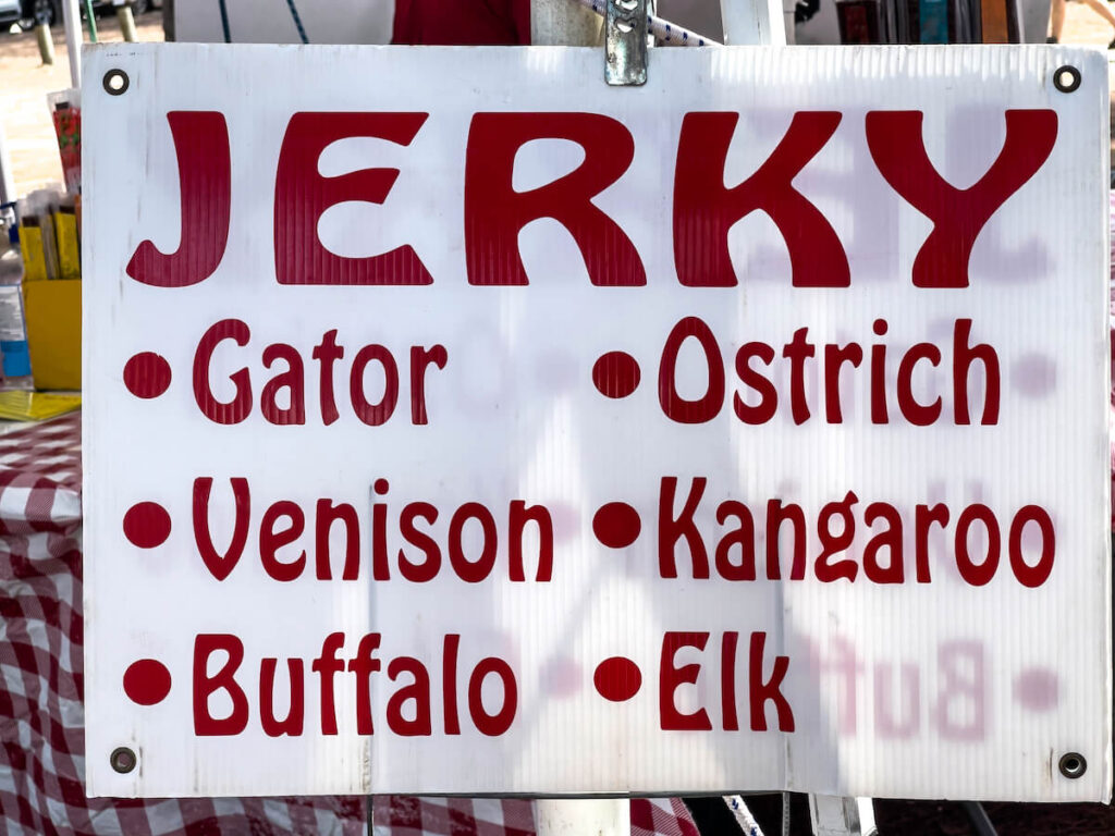 Sign at pop-up shop that sells domestic and exotic jerkies, including alligator and kangaroo, at a beach market in west central Florida