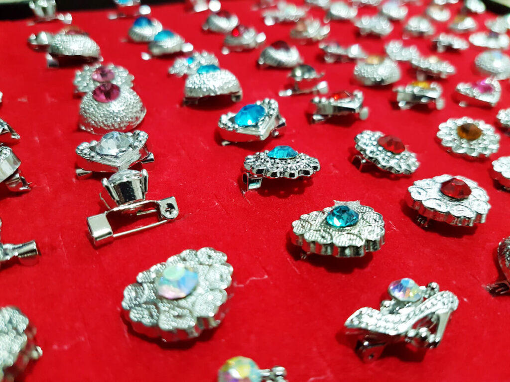 Brooch in different pattern,color and design on red velvet