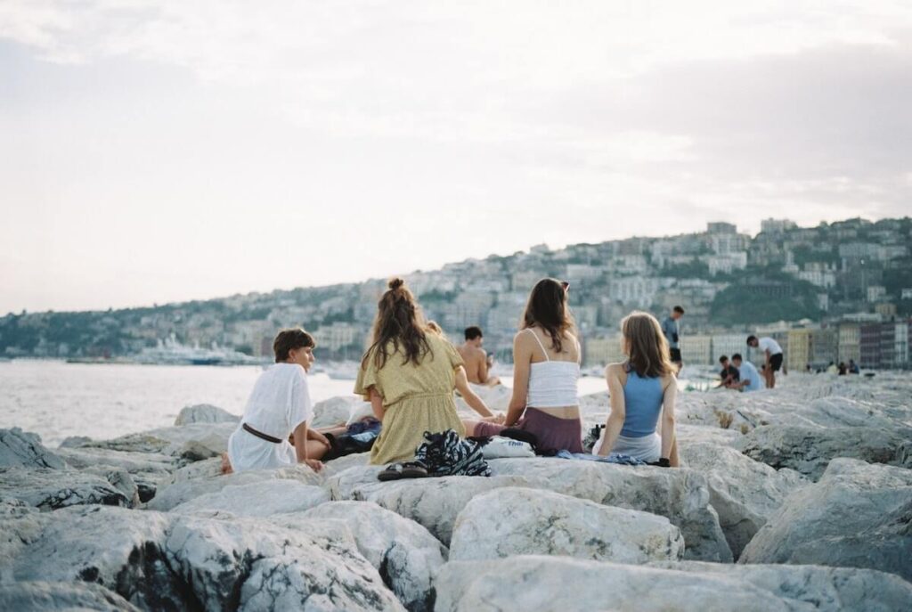friends hang out on naples rocky waterfront