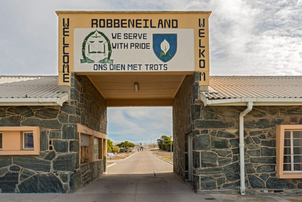People walking into Robben Island Prison where Nelson Mandela was imprisoned, now a museum