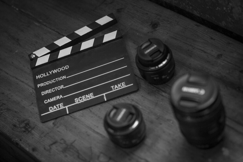 filming clapper slate and camera lens on table