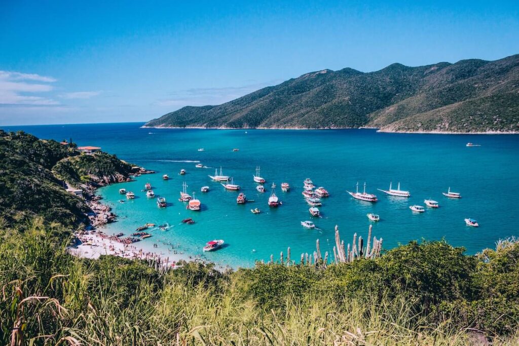 boats anchored by pristine arraial do cabo beach