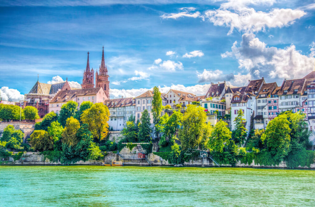 Riverside of Rhine in Basel dominated by majestic building of Munster church