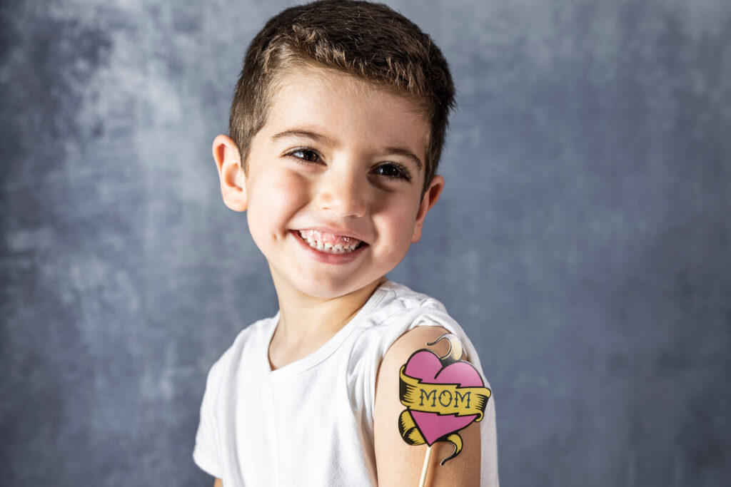 Little child with a Love Mom tattoo