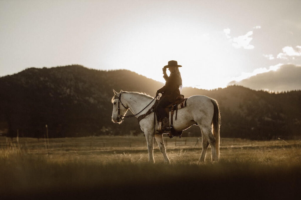 cowgirl on horse in field