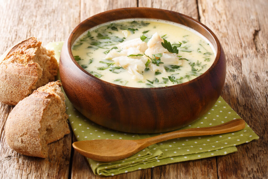 Delicious cream soup cullen skink cooked with smoked haddock and potatoes close-up in a bowl on the table