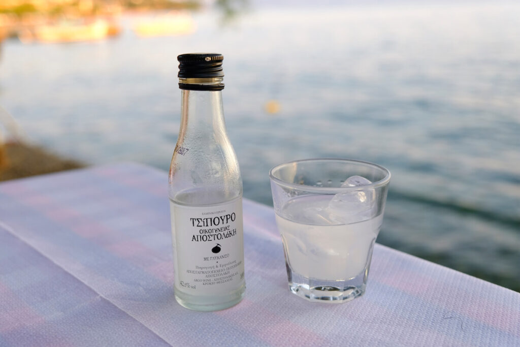 A glass and bottle of traditional drink Ouzo or Raki in Afissos village in Greece
