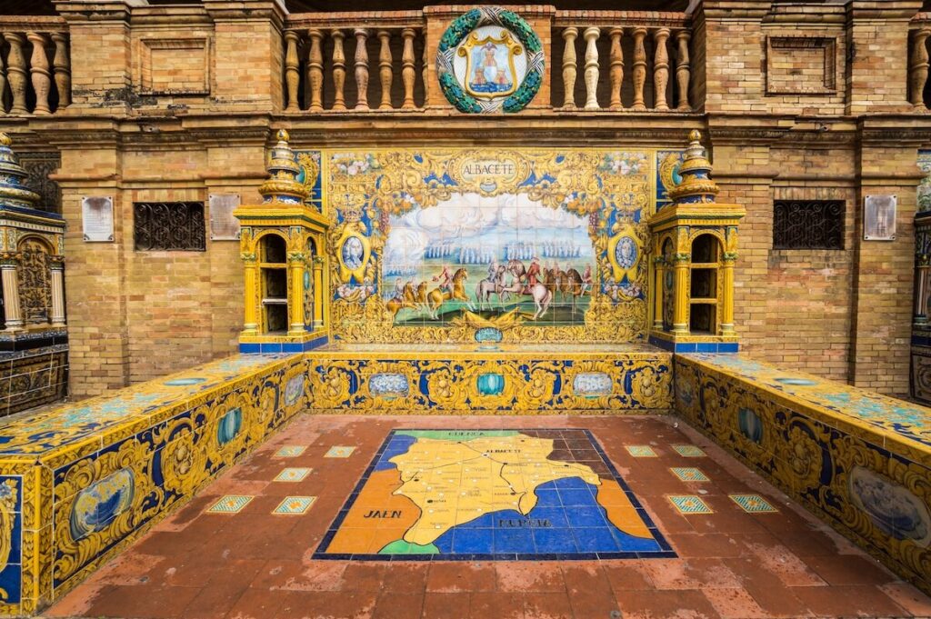 The tiled Provincial Alcoves along the walls of the Plaza de Espana in Seville, a big tourist centre in Spain