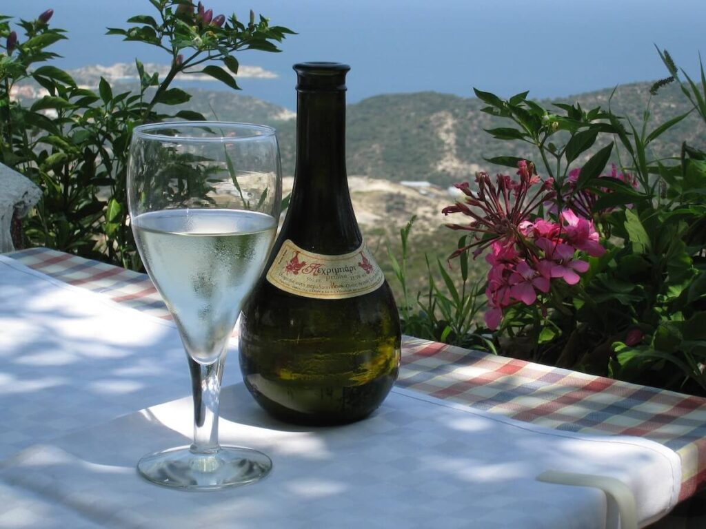 wine bottle and wine glass overlooking mountain