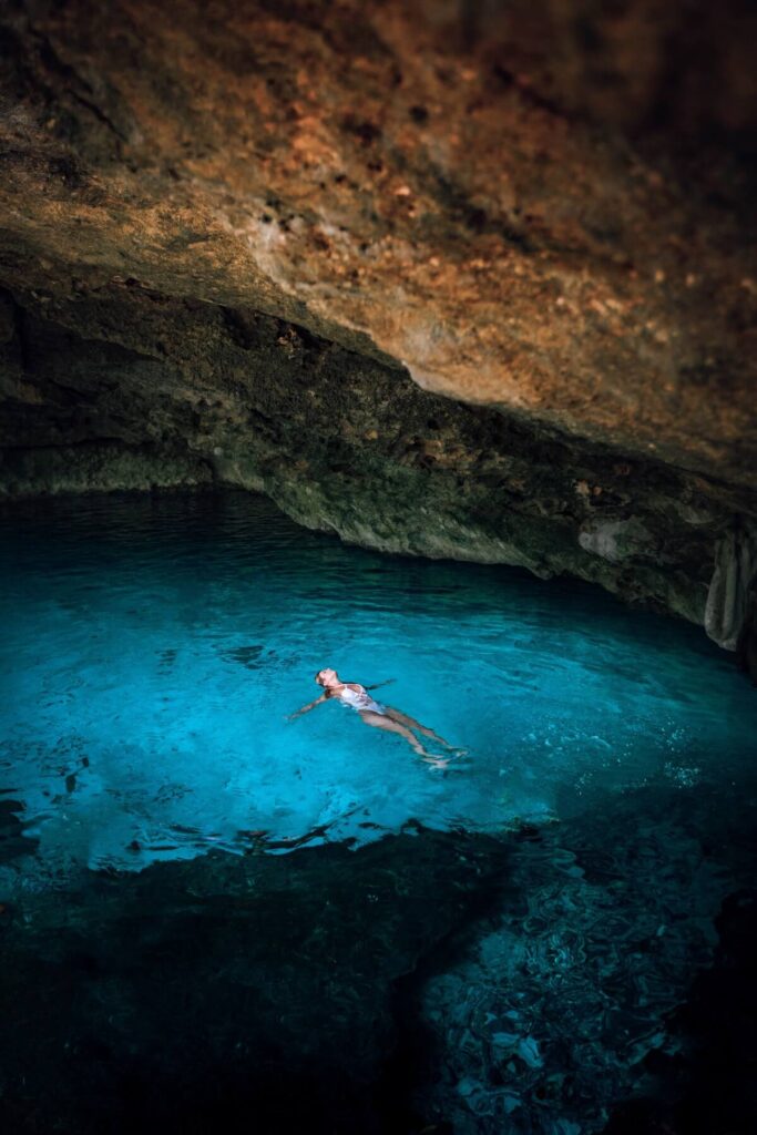 Woman floating in the Dos Ojos Cenote, Tulum