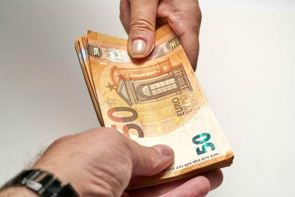 Close-up of two hands of people exchange a 50 euro notes to buy and sell