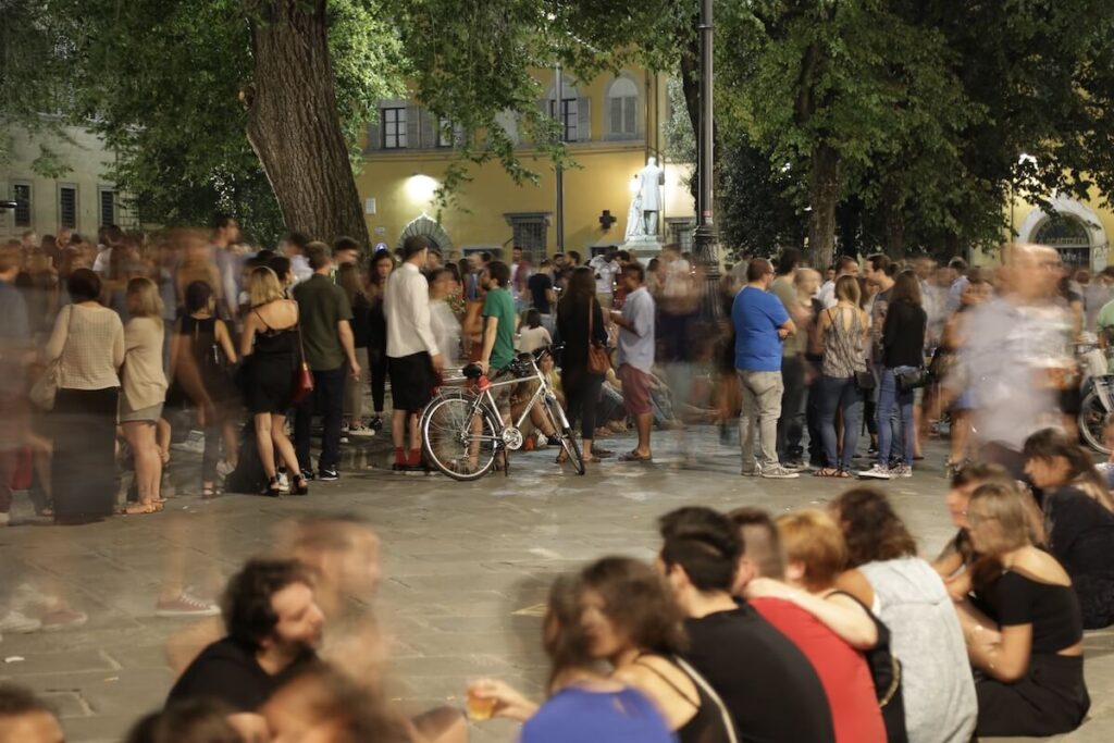 Students milling around Piazza Santo Spirito on a typical summer Saturday night
