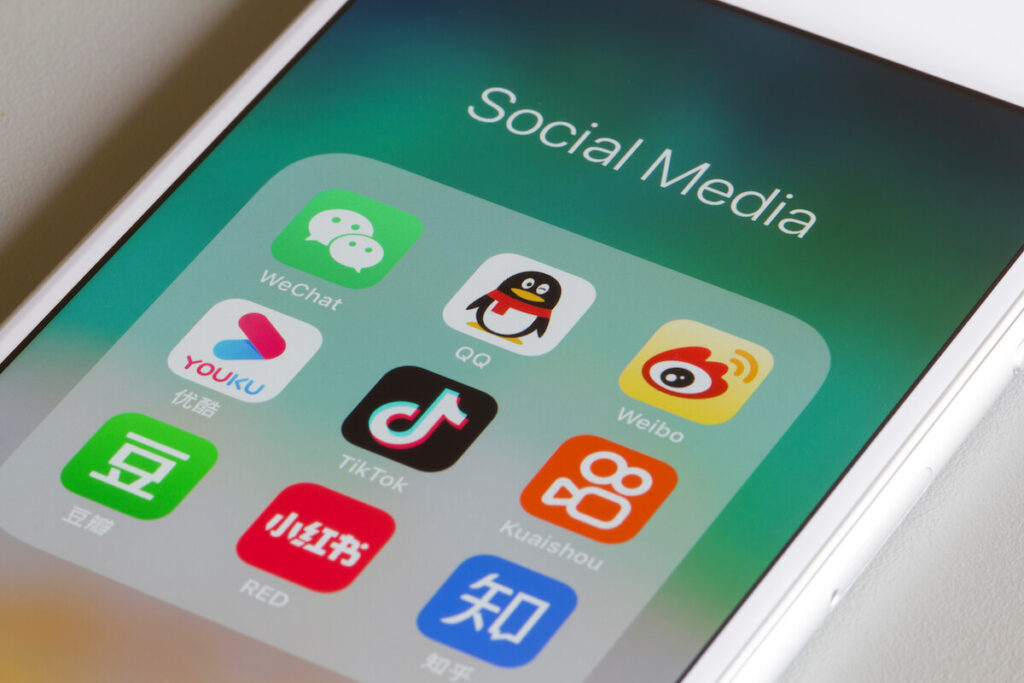 Assorted Chinese social media apps are seen on an iPhone, including WeChat, QQ, Weibo, Youku, TikTok, Kuaishou, Douban, Xiaohongshu, and Zhihu