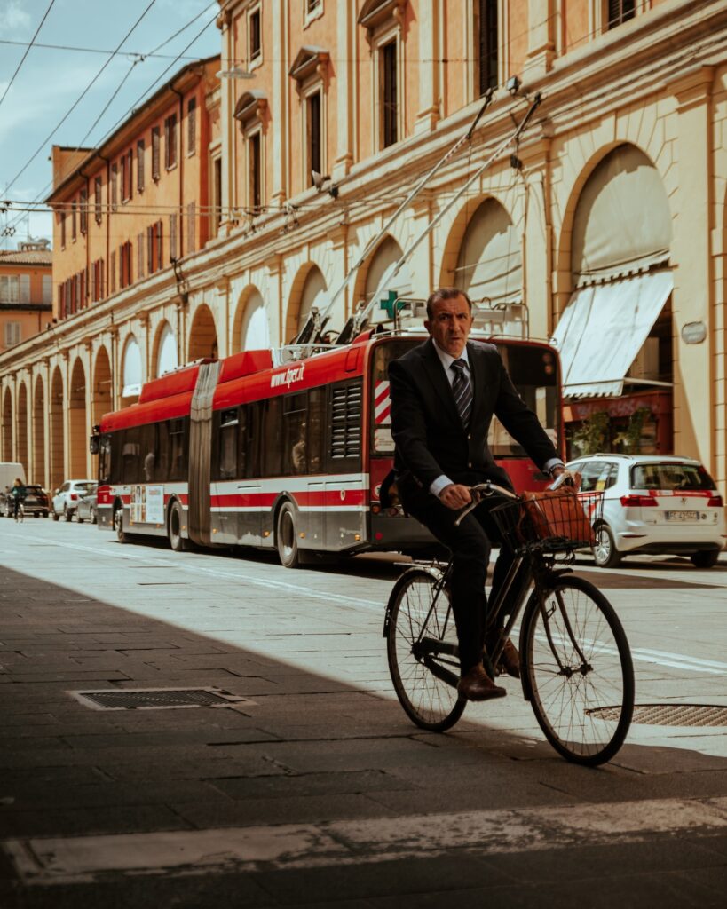 businessman cycles to work in bologna