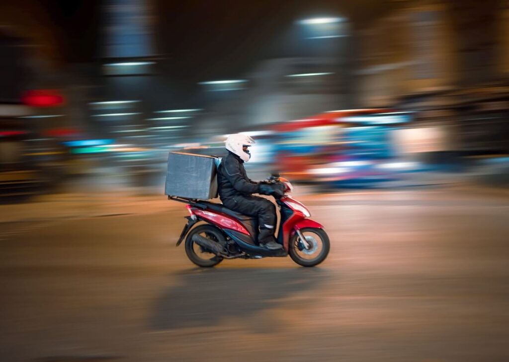 food delivery man riding through the night