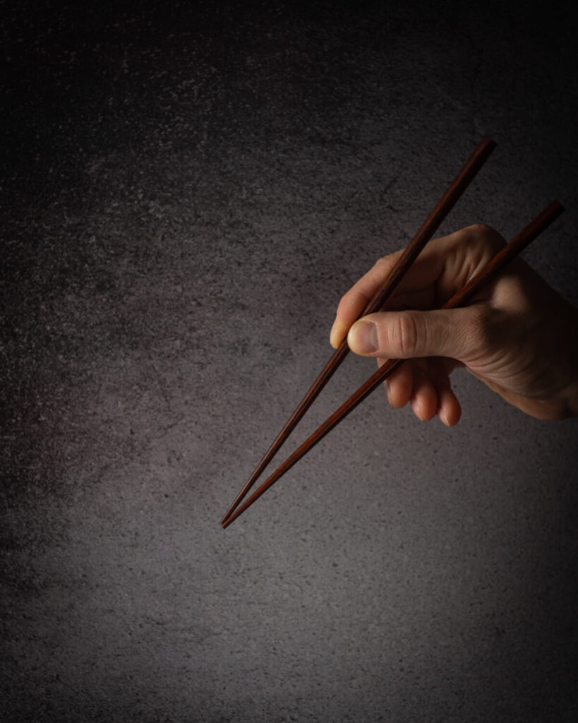 hand holding chopsticks