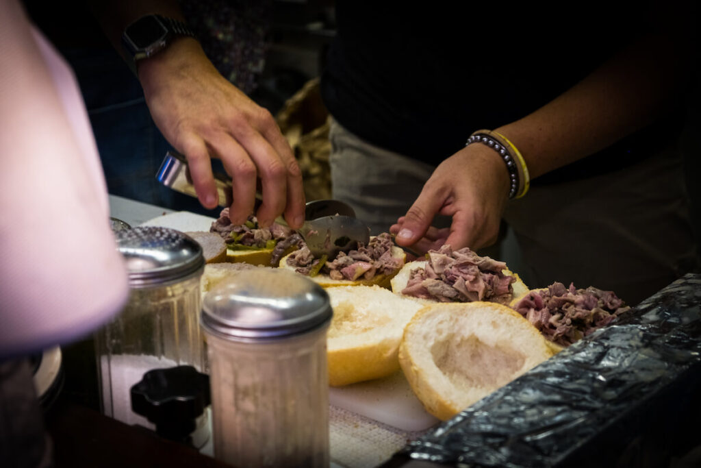 The preparation of sandwiches with lambredotto, a typical Tuscan street food