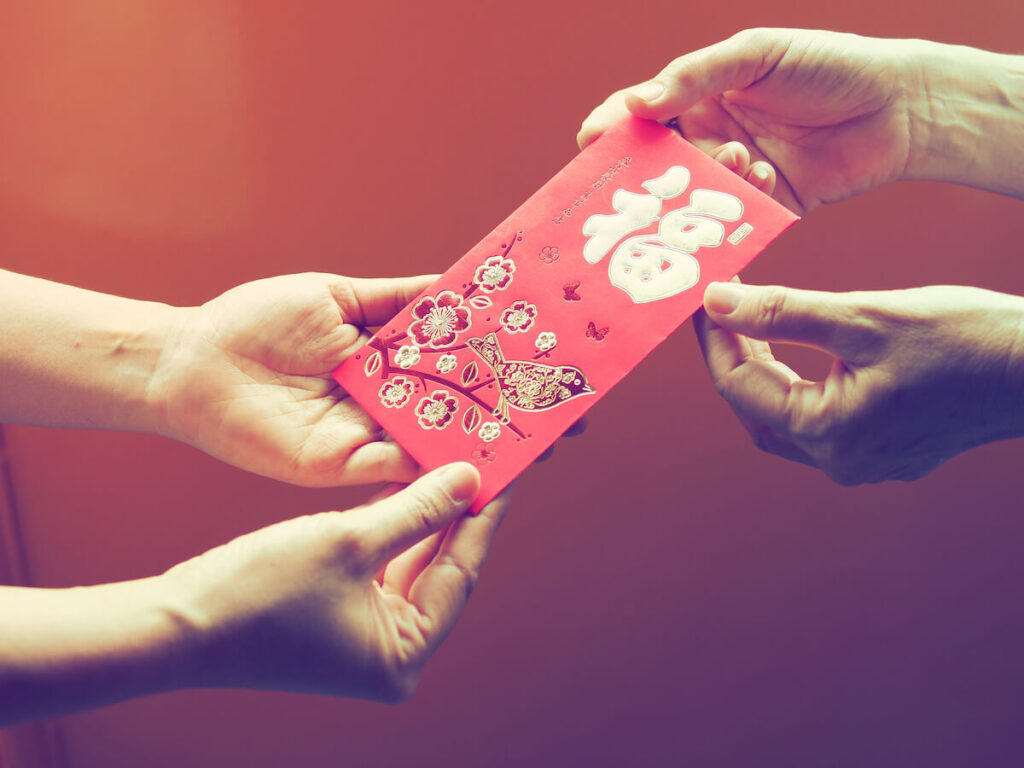 receiving red envelope known as angpow during Lunar New Year