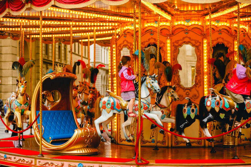 children riding the carousel