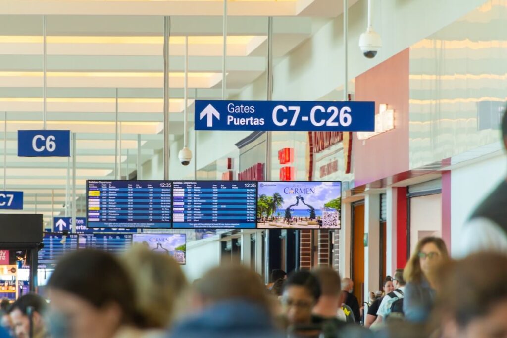 A large crowd of people fill up the halls of the Cancun International Airport in Mexico