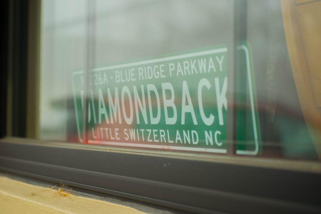 Street sign for the Diamondback, NC, behind a glass window