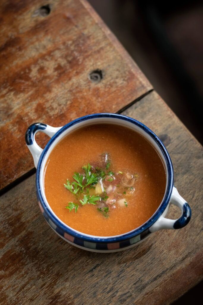 Spanish traditional gazpacho cold vegetable soup in rustic Seville restaurant