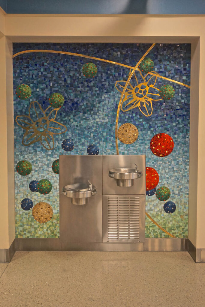 A section of “Celestial Playground,” a mosaic mural by New York artist Amy Cheng, surrounds the water fountain at JAX Airport in Jacksonville, Florida
