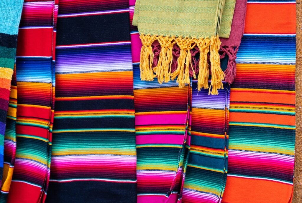 Colorful Mexican serape stripes blankets in street market
