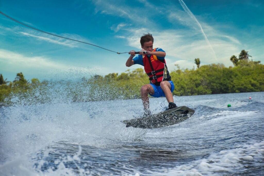 teenage boy wakeboards in Cancun
