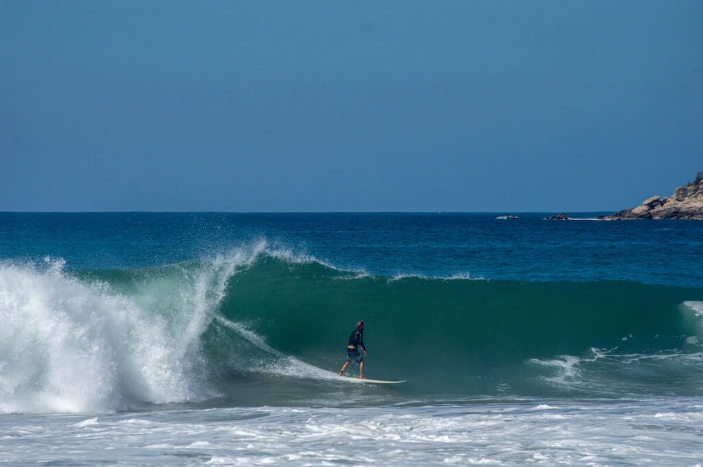 a man riding a wave on top of a surfboard