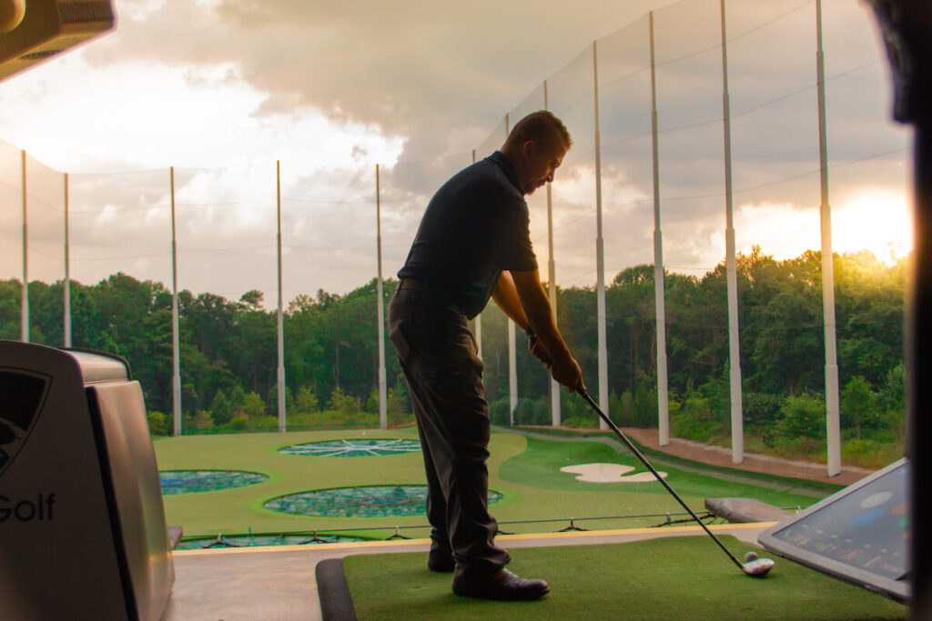 man playing golf at TopGolf at Atlanta Midtown