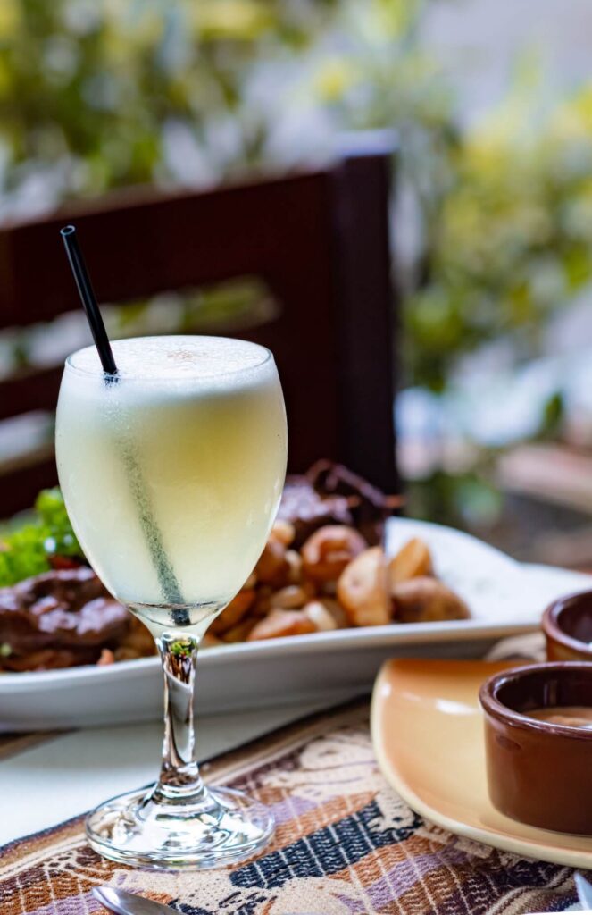 pisco sour and peruvian dishes on table