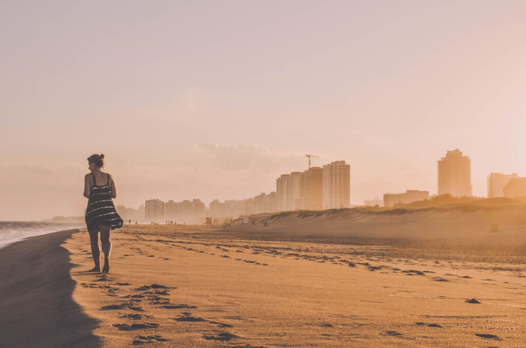 woman walks on punta del este beach