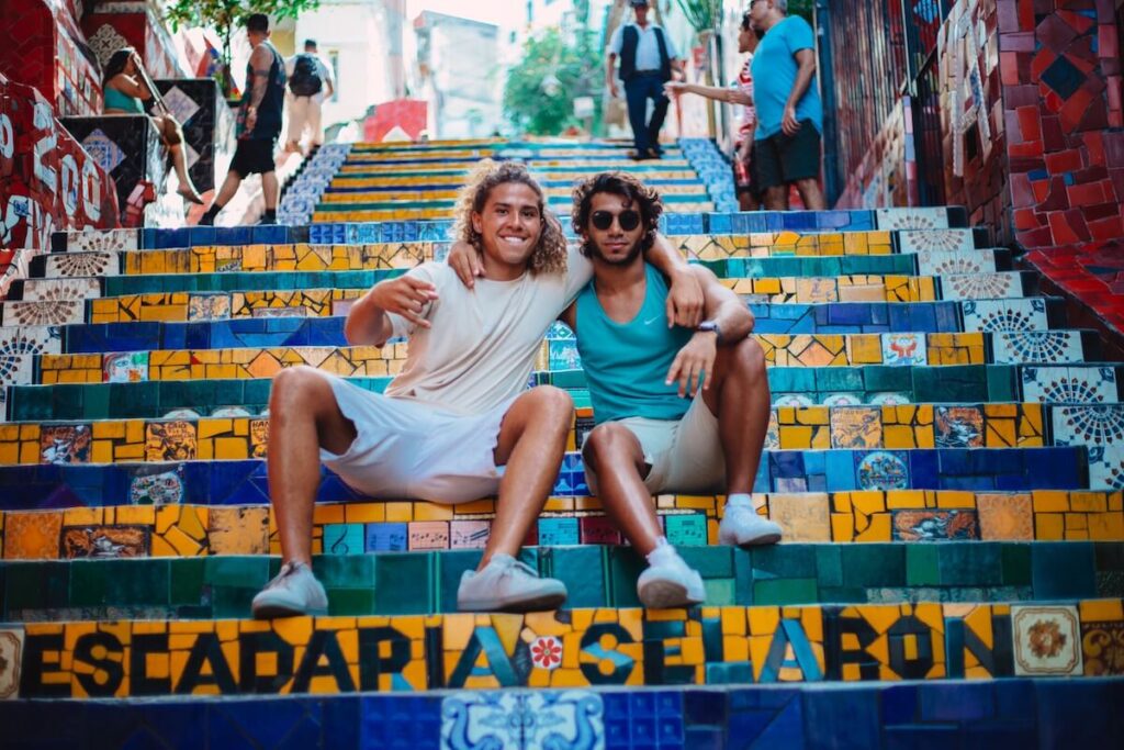 two young men sitting on selaron steps