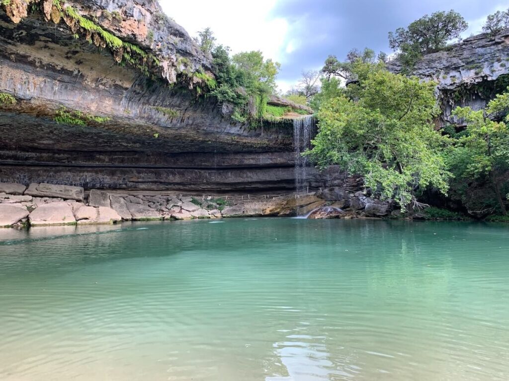 Waterfall over cliff into pool
