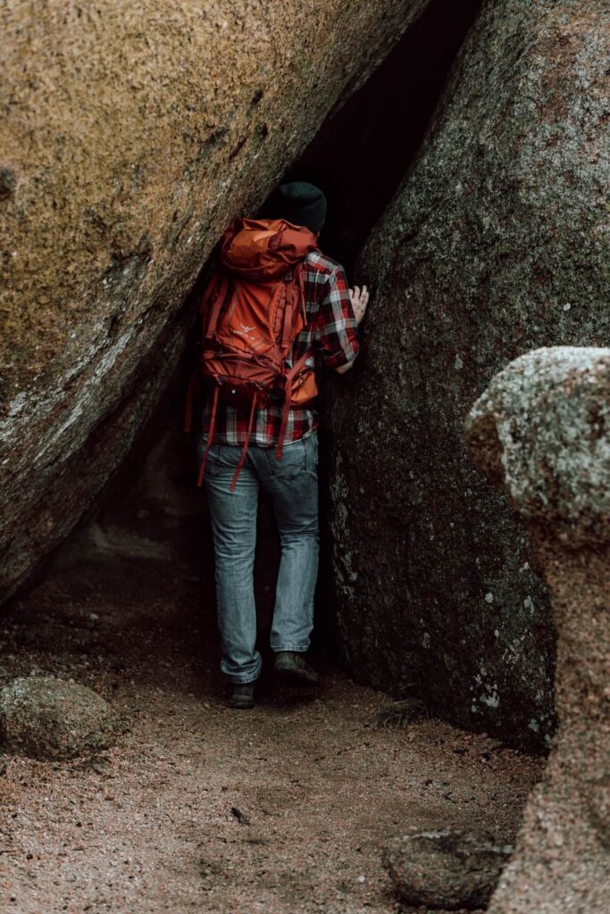 Hiker enters rock cave