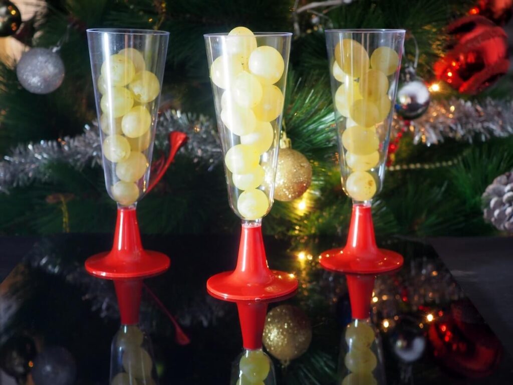 Twelve grapes in glasses, with Christmas decor