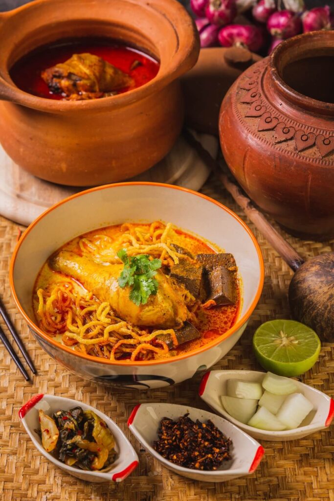 Khao Soi Kai, delicious northern Thai food, Arranged with seasonings on the table
