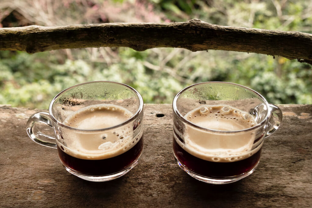 Two cups of Thai coffee on wooden table