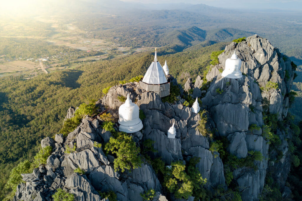 Spectacular aerial view of floating pagodas on the mountain cliff at Wat Chaloem Phra Kiat in Chae Hom District, Lampang province, Thailand