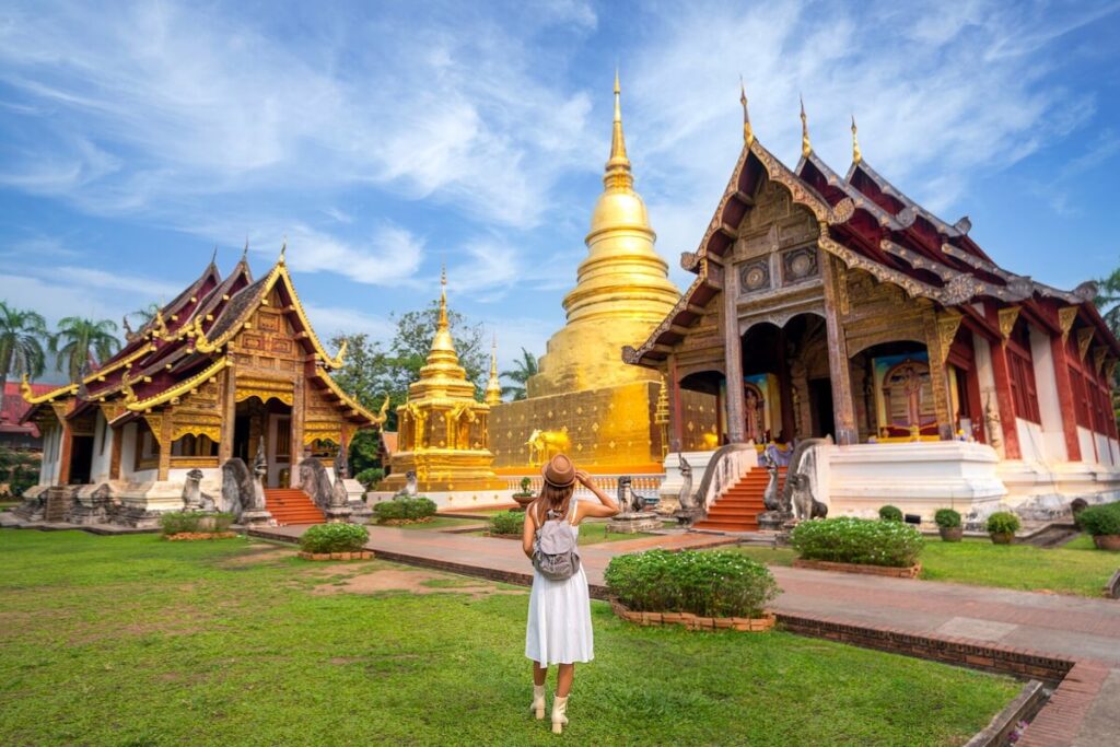 woman standing in front of Wat Phra Singh in Chiang Mai, Thailand