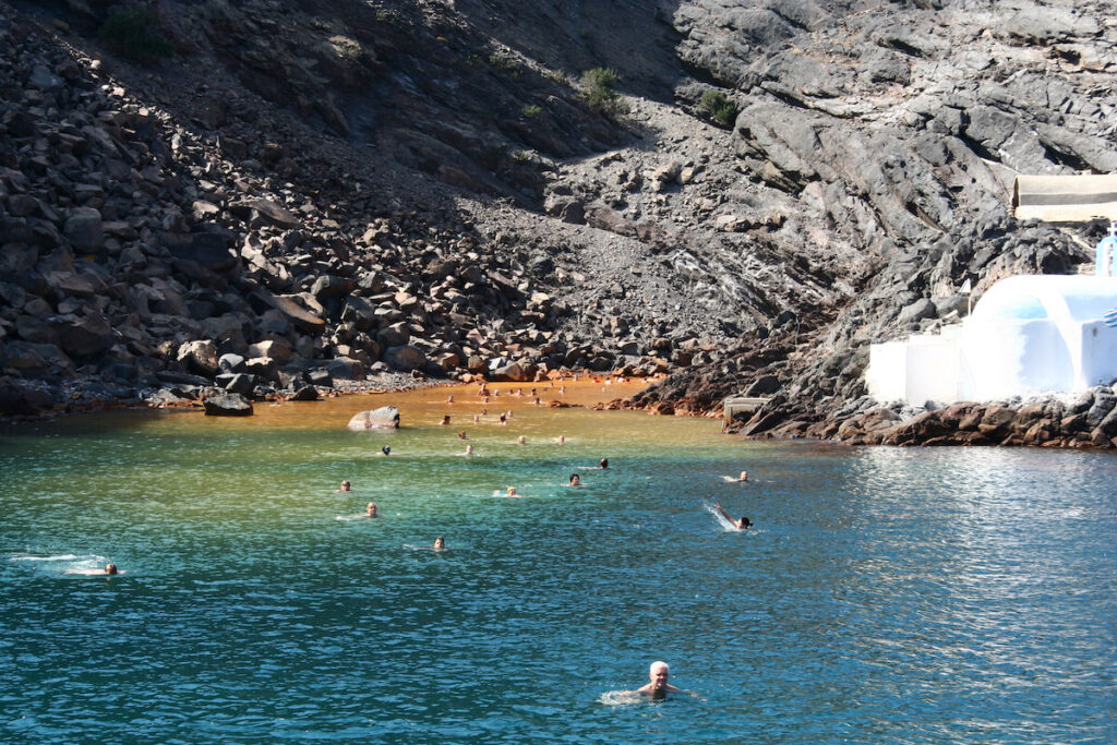 people swimming in a hot spring in Greece