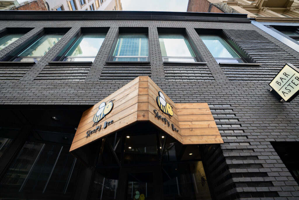 Low angle image of the Sleepy Bee Cafe sign in Downtown Cincinnati