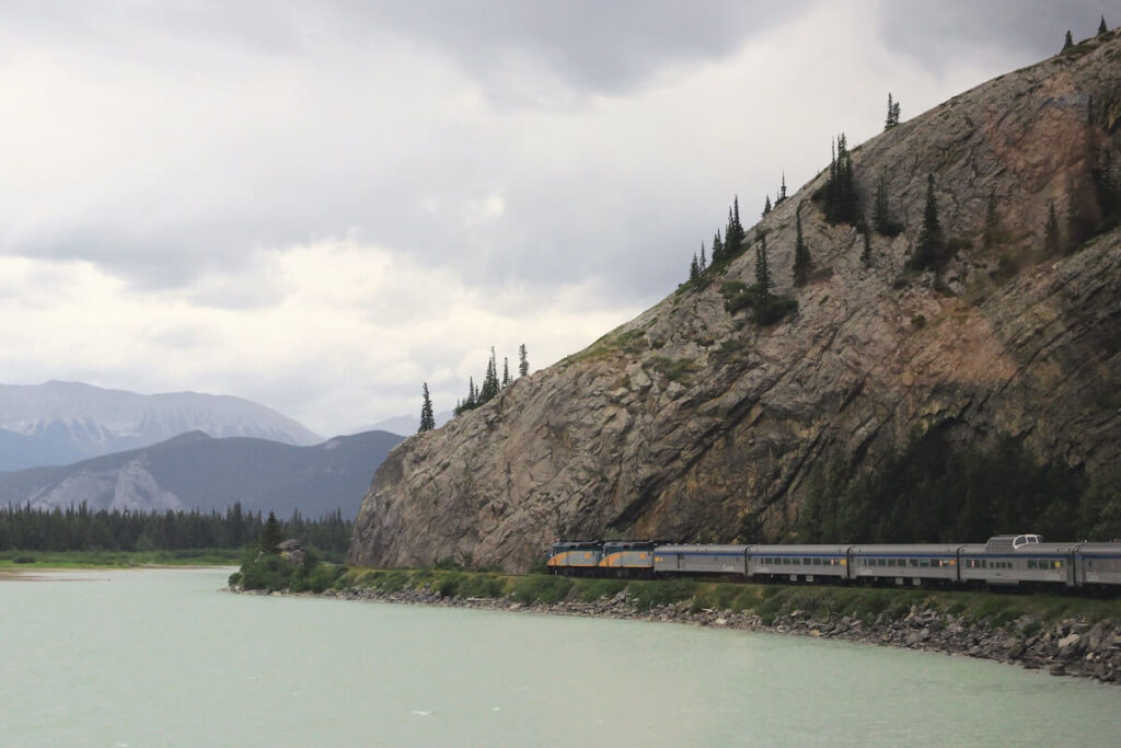 Silver train along river bluffs