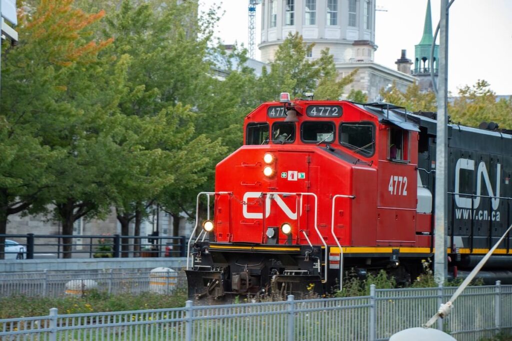 red train passing through the Old Port of Montreal