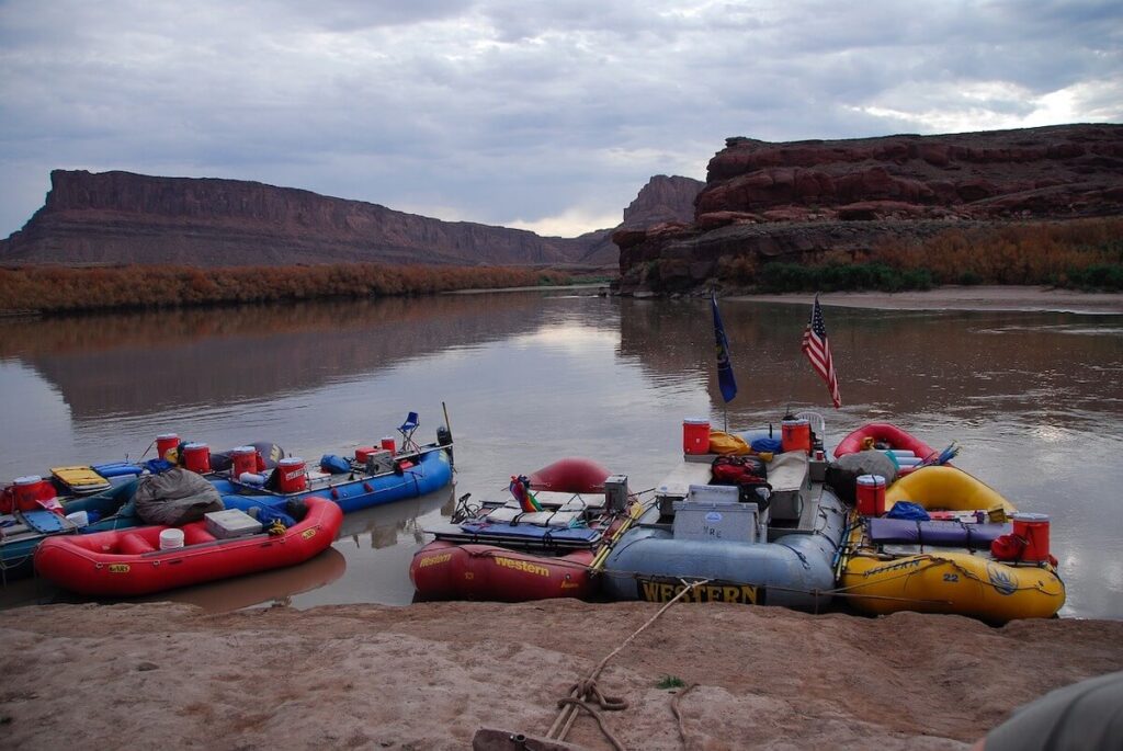 rafts parked beside river canyon