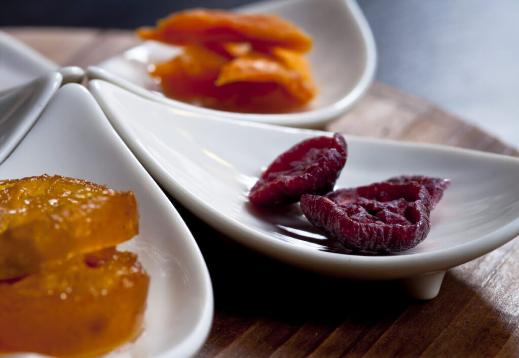 assorted dried fruits in white plates