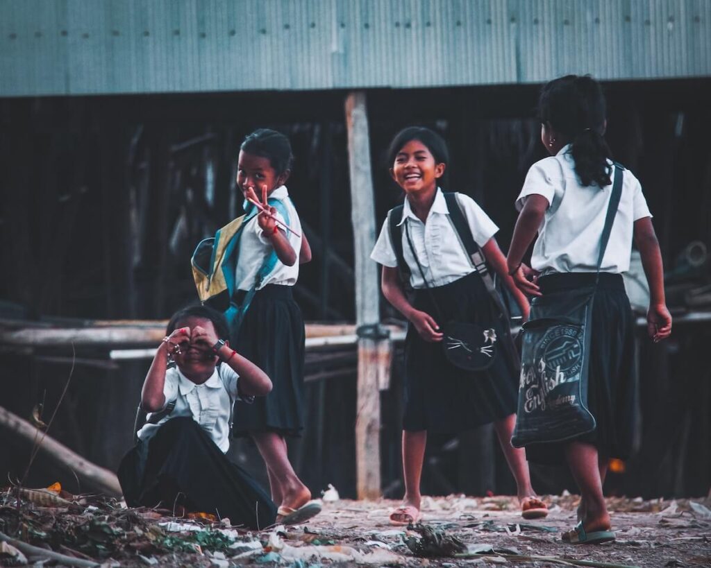 a group of young Cambodian children laughing and smiling