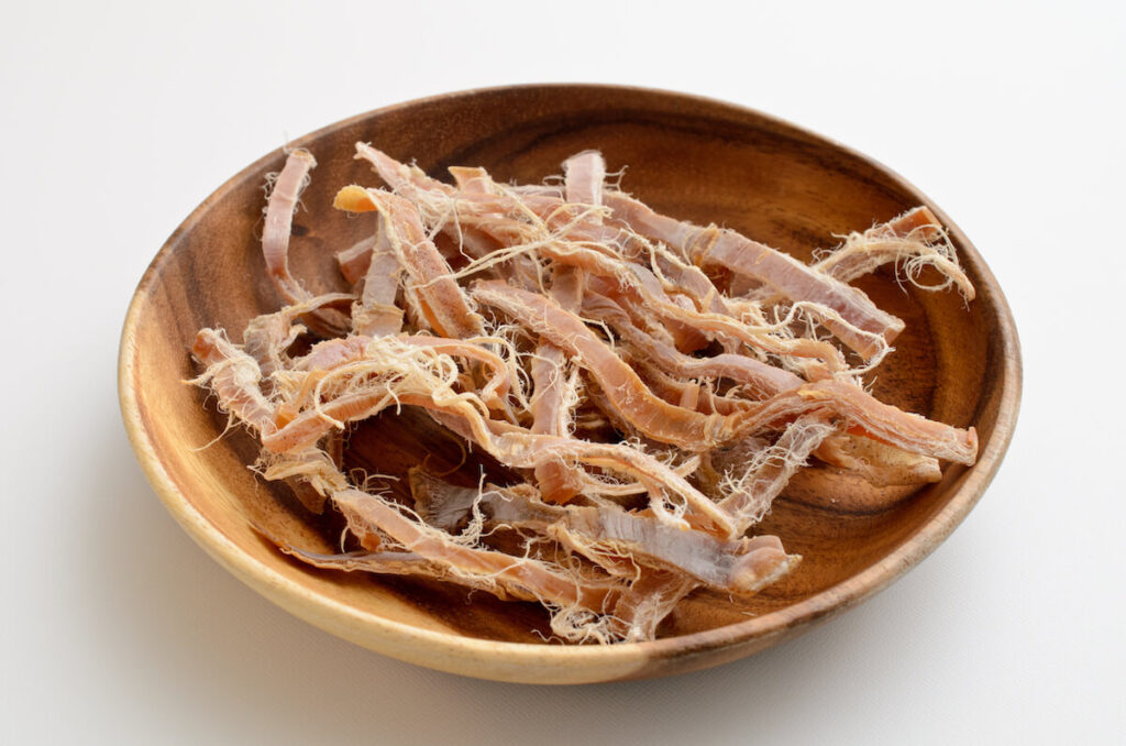 dried squid snack in wooden bowl