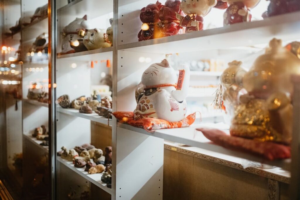 ceramic figurines including lucky cat on display